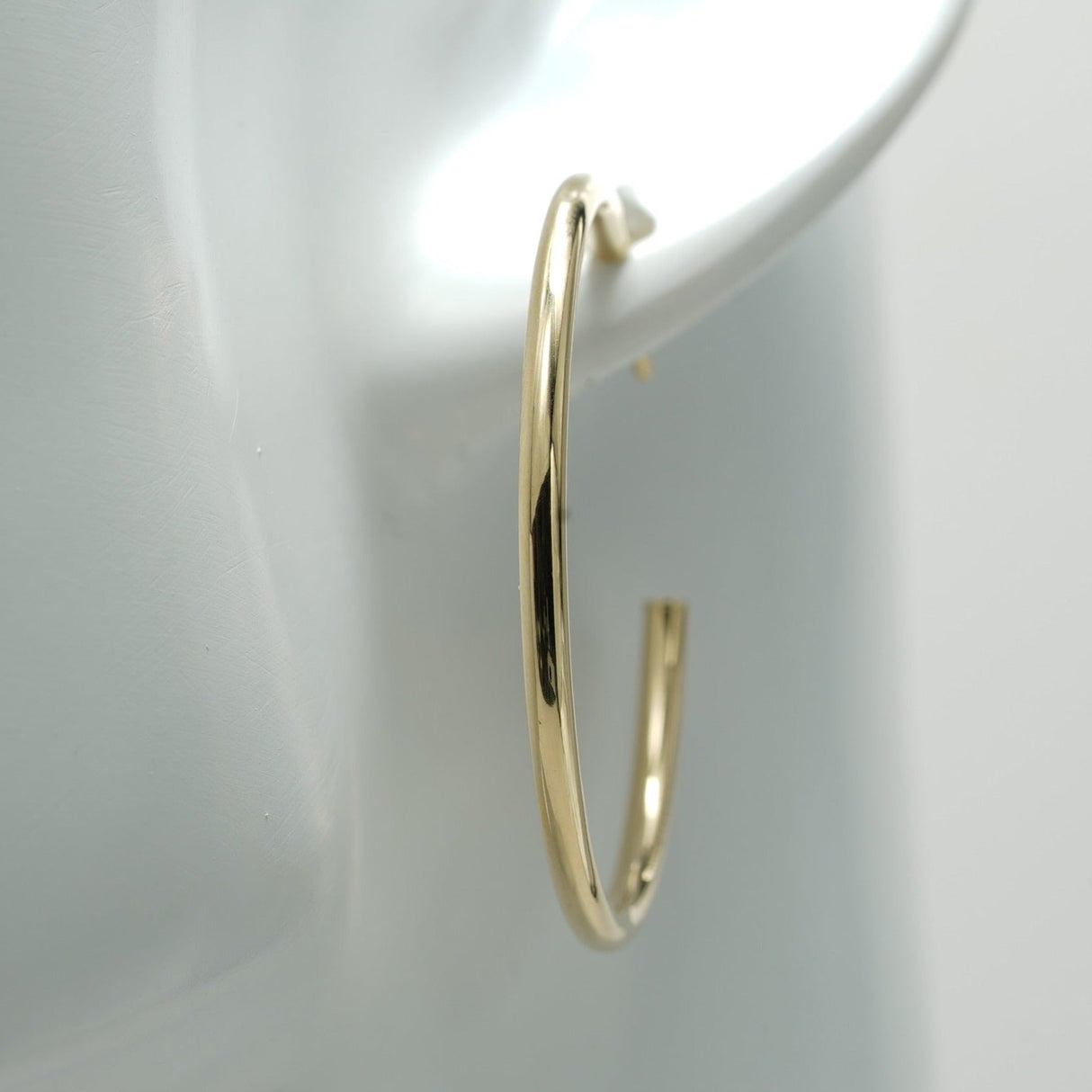 our gold hoop earrings are made from the highest quality materials, ensuring that they're durable, long-lasting, and resistant to wear and tear. Whether you're wearing them to a special event or for everyday wear, you can trust that these earrings will maintain their shine and luster for years to come.