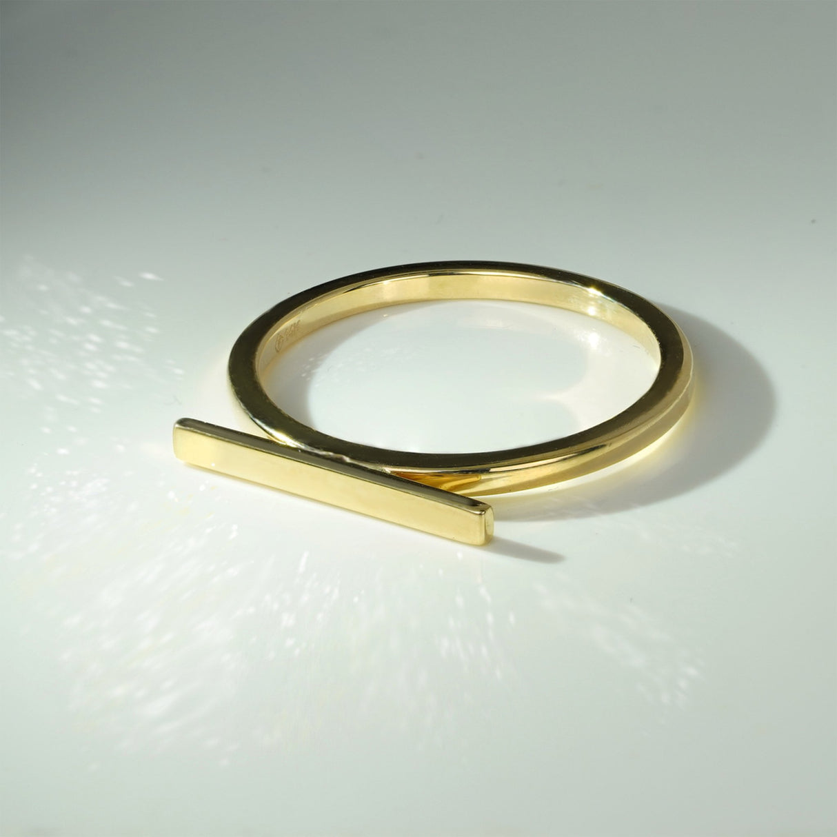 A minimalist yet striking 2mm gold ring with a horizontal bar, a symbol of strength and stability, offering an understated touch of luxury, gold stackable ring, gold stackable rings, gold ring, gold rings, 14K gold ring, 14K gold rings, gold fashion ring,